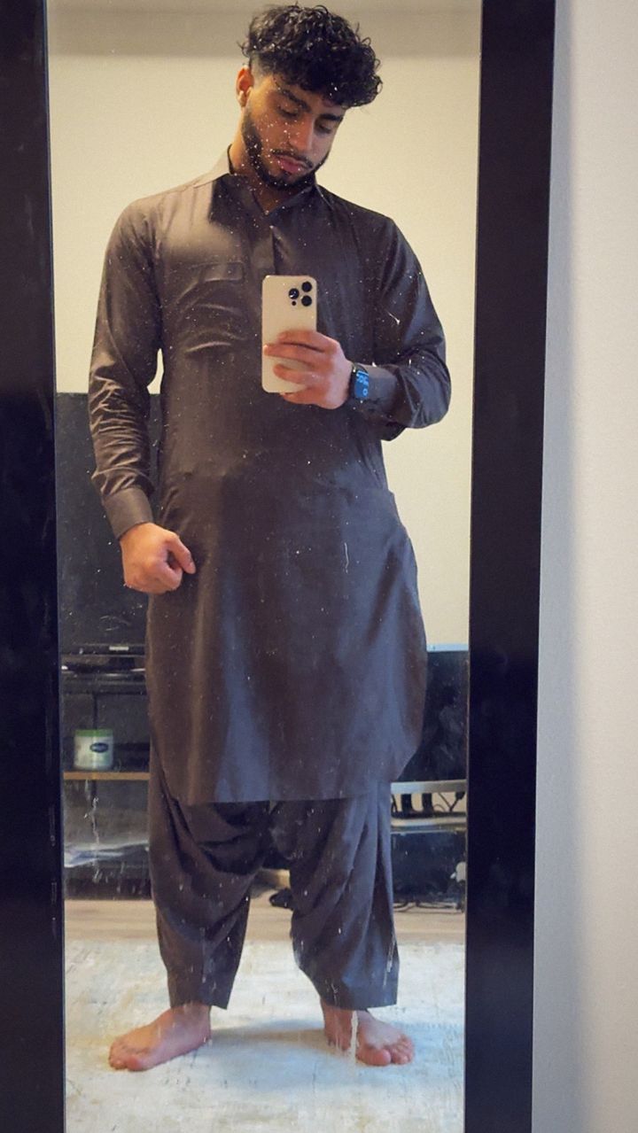 Young Momo (YNGM0M0) mirror selfie in a brown shalwar kameez